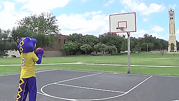 purple dinosaur mascot shoots an airball on a basketball court